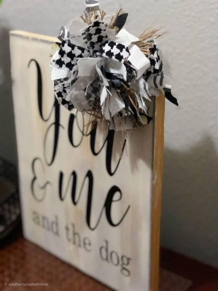 Scrap material turned into a messy bow, then attached to a sign.