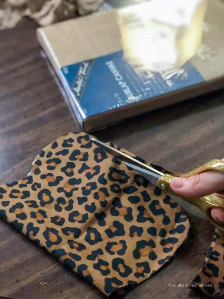 Cutting leopard print fabric for a DIY pumpkin wall art 
