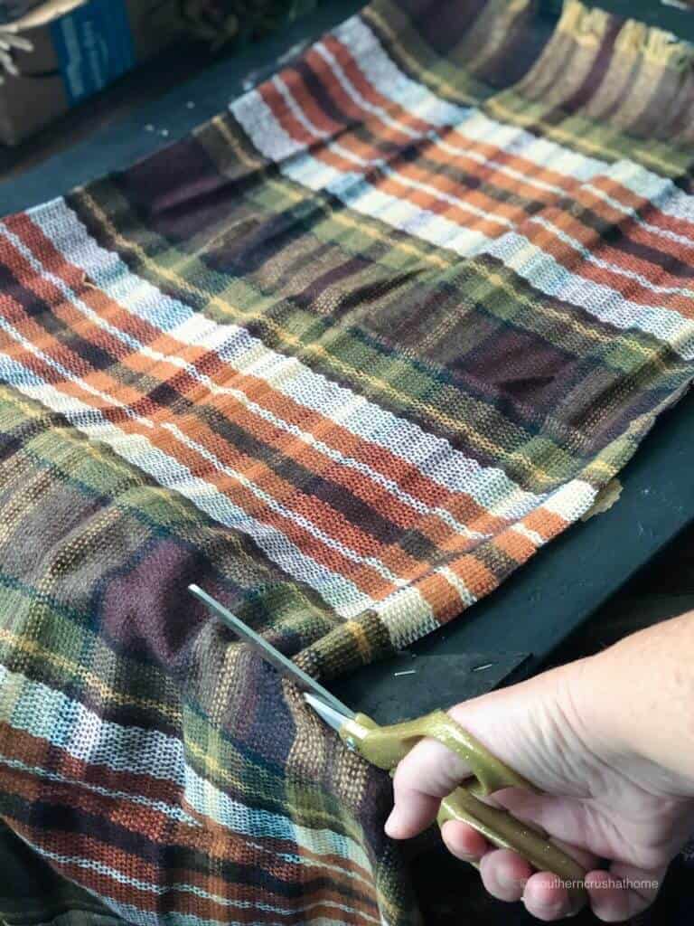 Trimming plaid material to fit the frame 