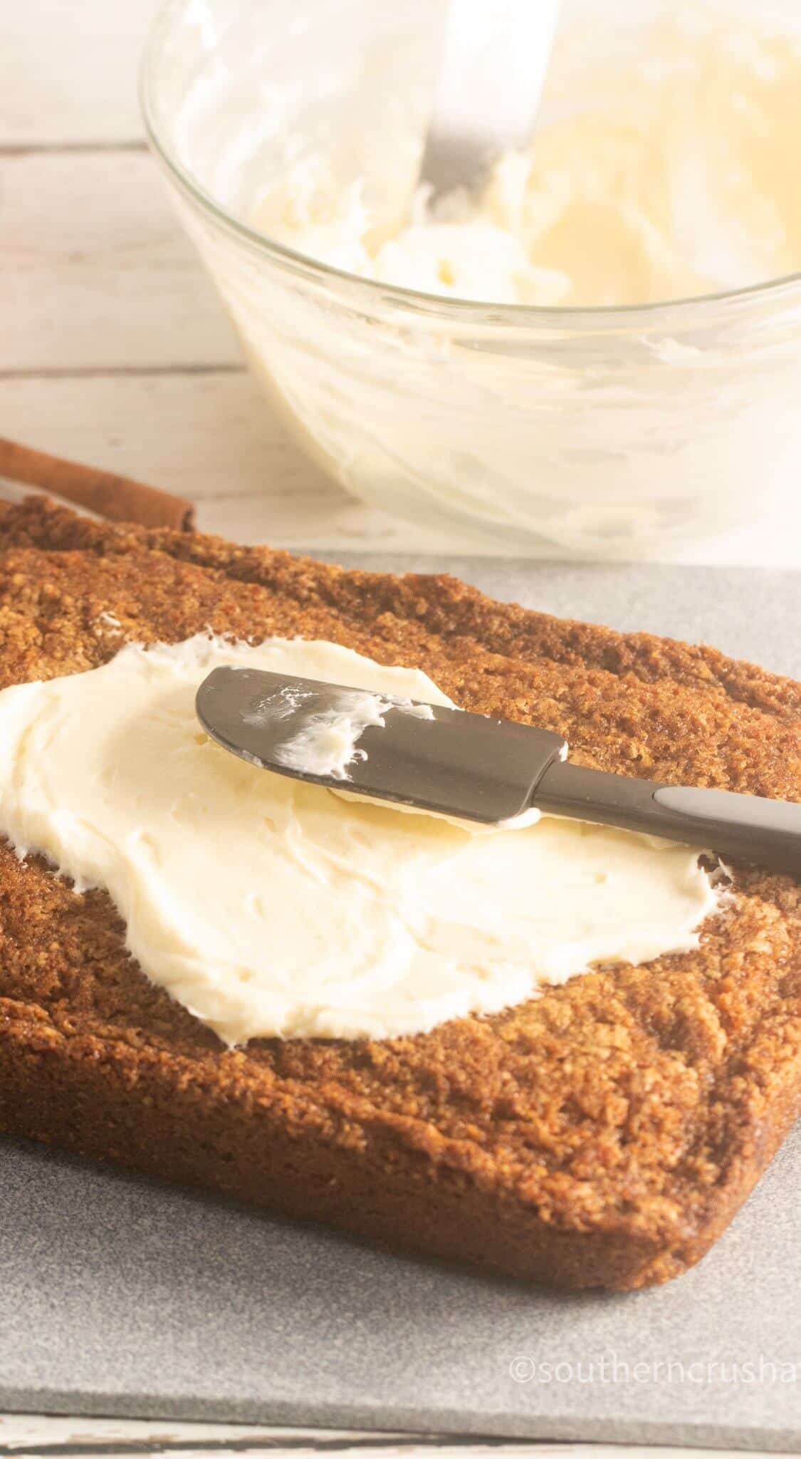 Easy Pumpkin Spice Cake for Thanksgiving spreading frosting