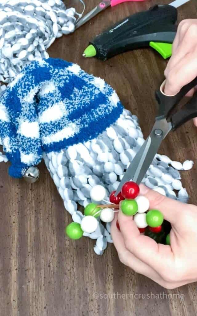 cutting a berry for the gnome ornament nose