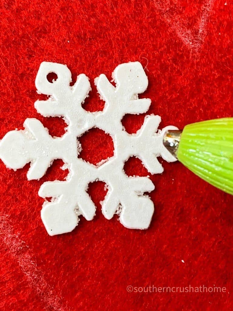 gluing snowflake ornament with hot glue
