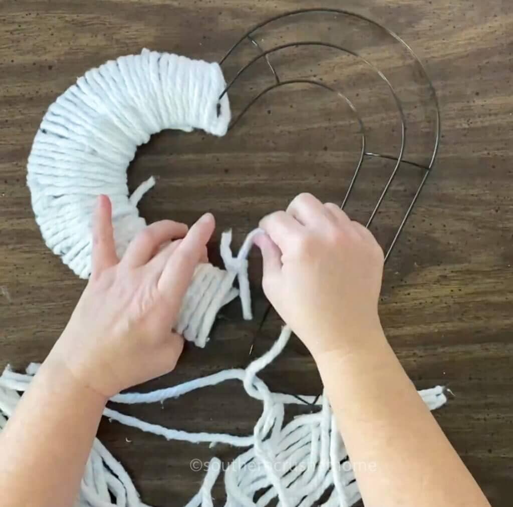 wrapping mop head strands around wire wreath frame