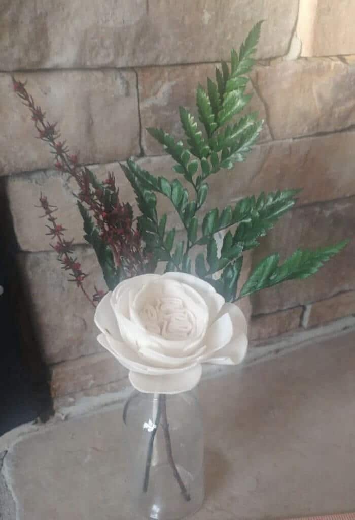 single wooden flower in vase