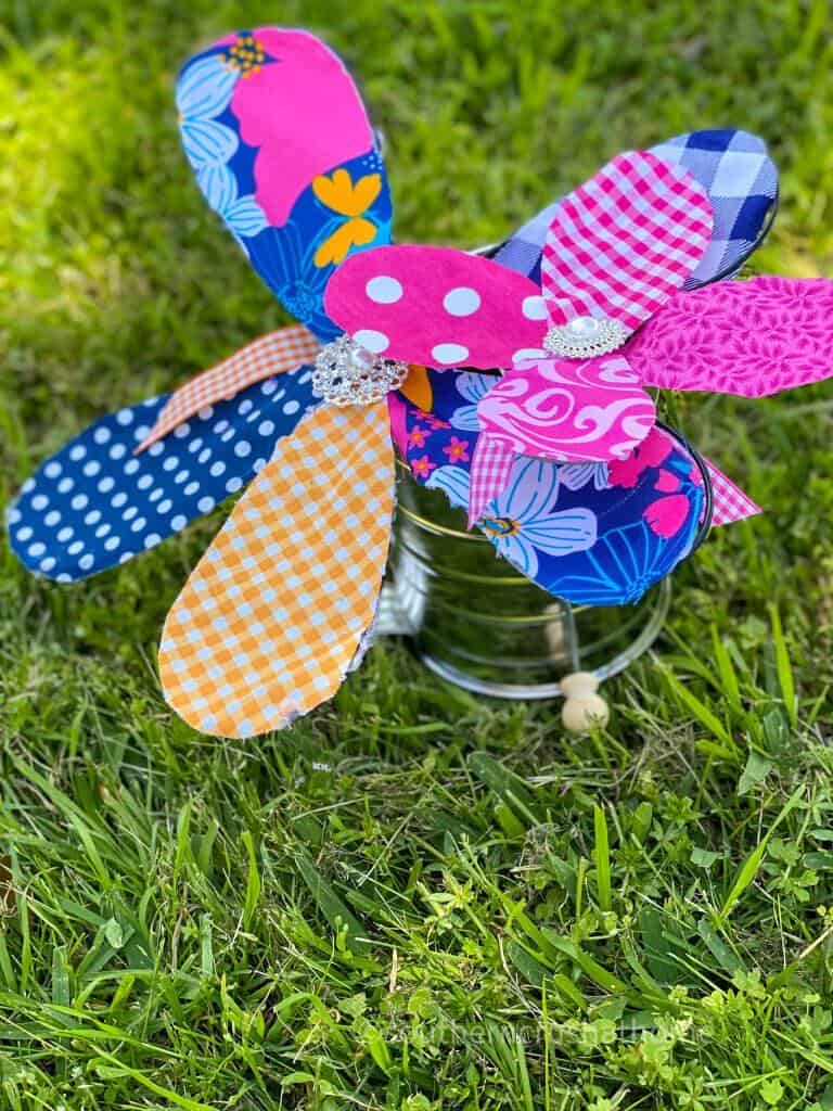 fabric flowers from kitchen whisk on grass