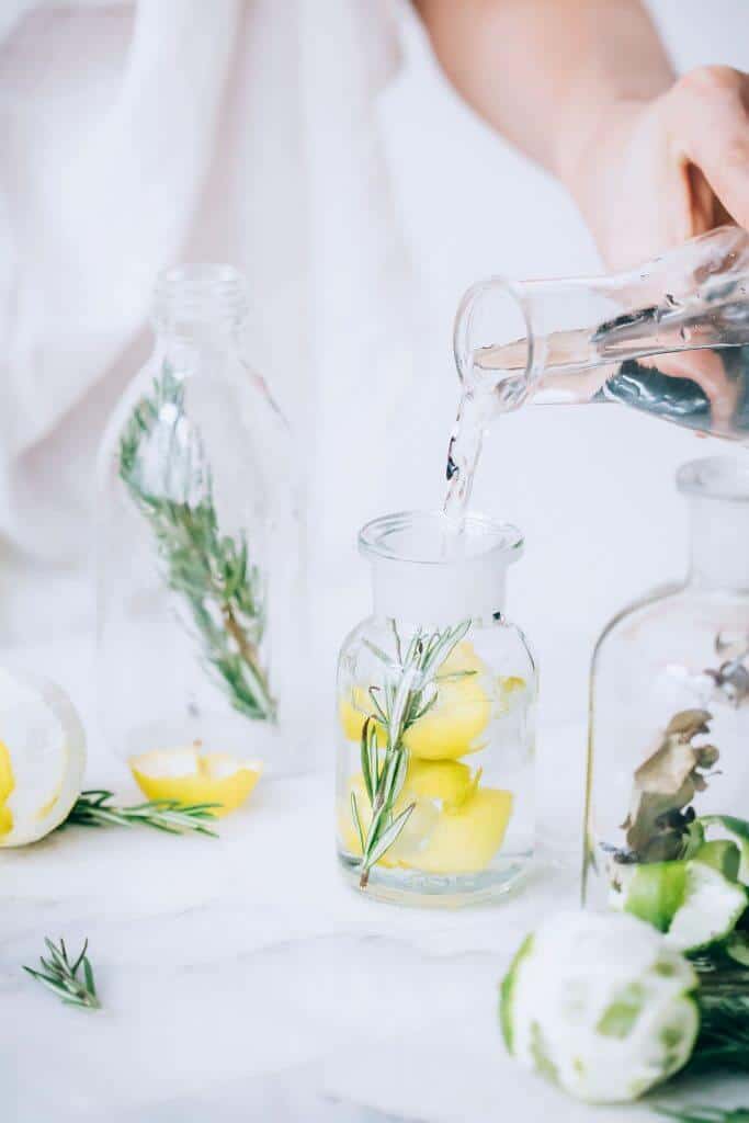 DIy infused vinegar on table with white backdrop