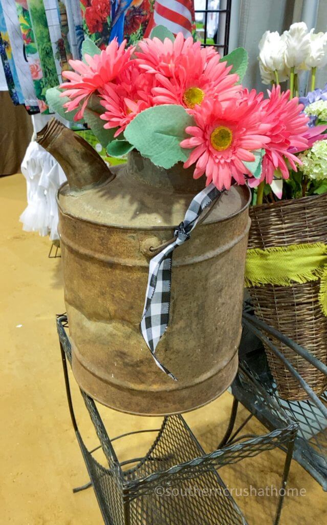gasoline can with faux flowers and buffalo check ribbon
