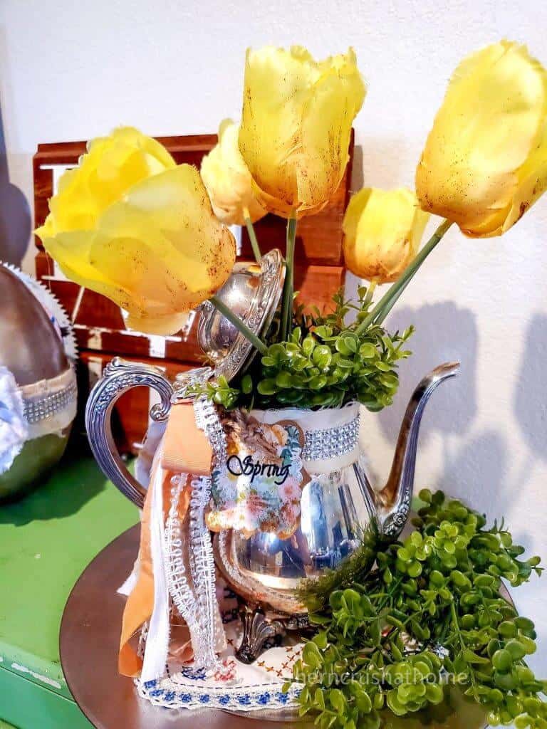 tea pot centerpiece on table with yellow roses