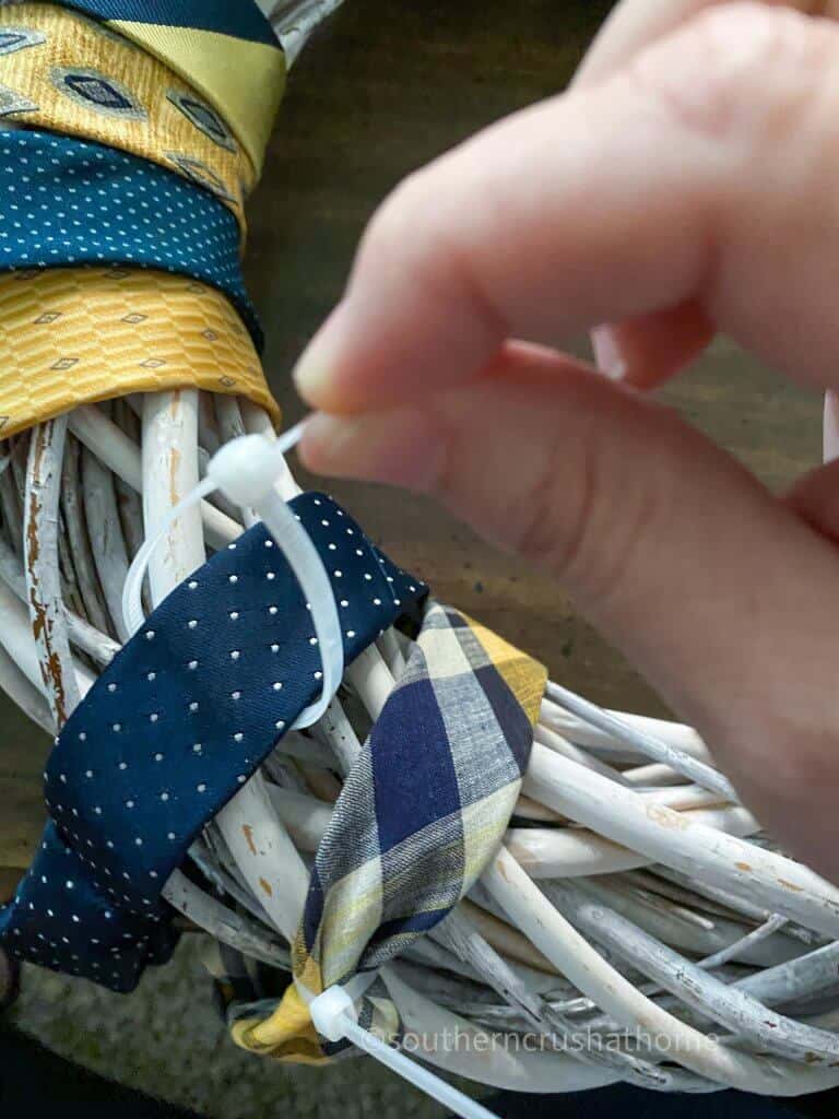 using zip ties to secure neckties to wreath