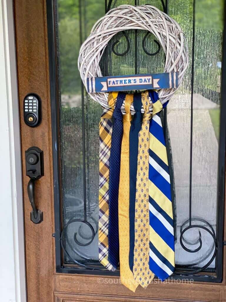 finished necktie wreath hanging on front door