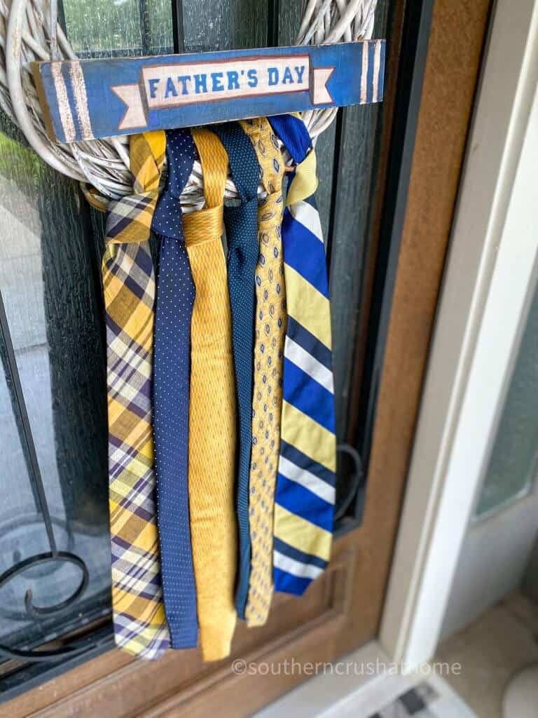 close up of necktie wreath on front door