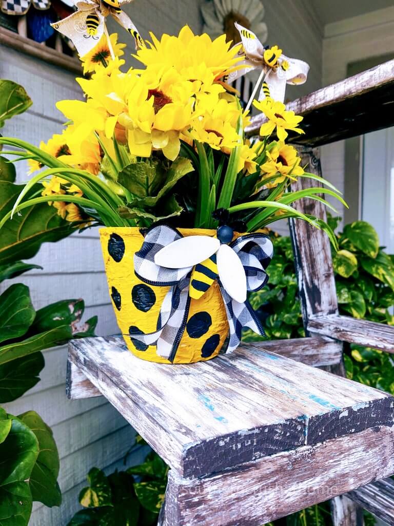 diy textured flower pot with yellow flowers on table