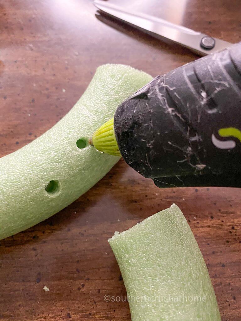 adding hot glue into holes for succulents