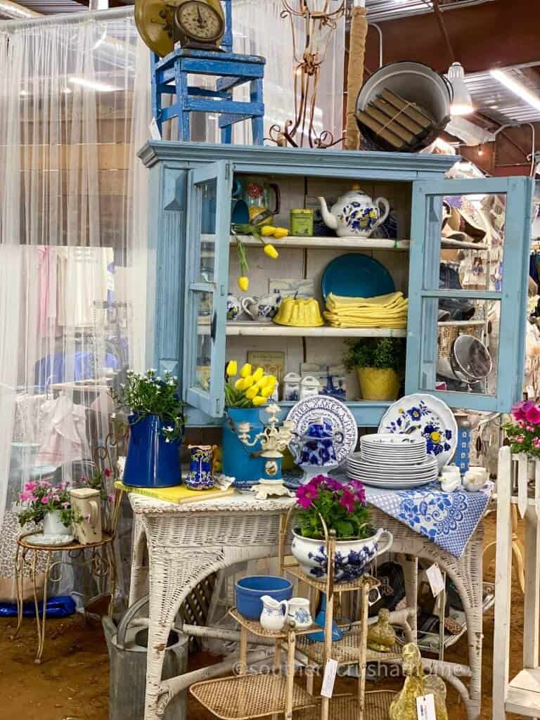 blue and white dishes in vintage cabinet display