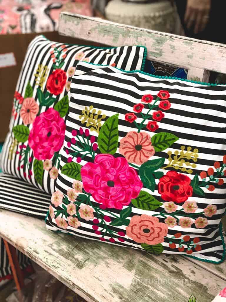 bright flowers on a black and white striped pillow