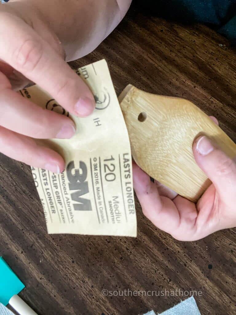 sanding wooden tag