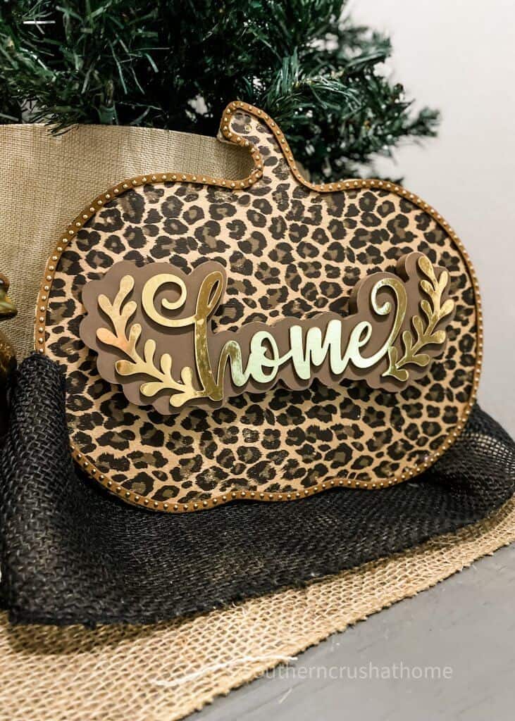 leopard foil pumpkin decor with home sign on table