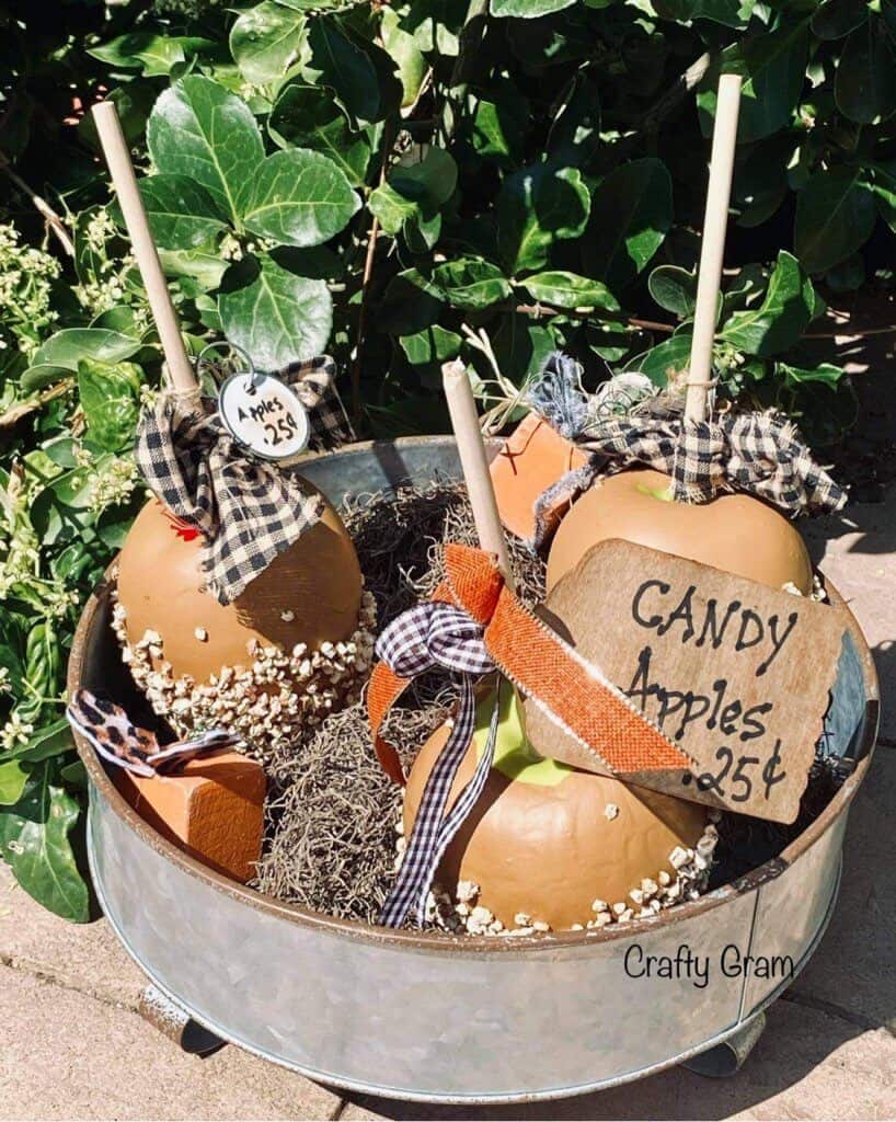 faux candy apples in bucket display