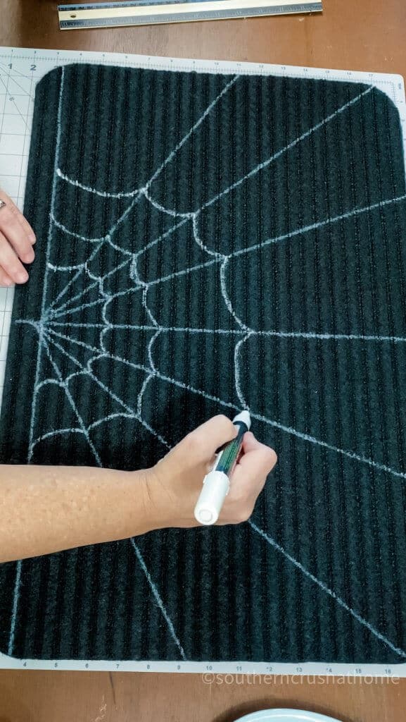 painting spiderweb on doormat