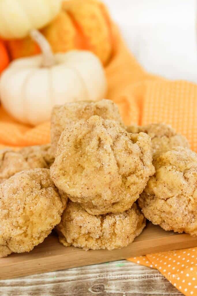 pumpkin spice cookies stacked with white pumpkin in the background