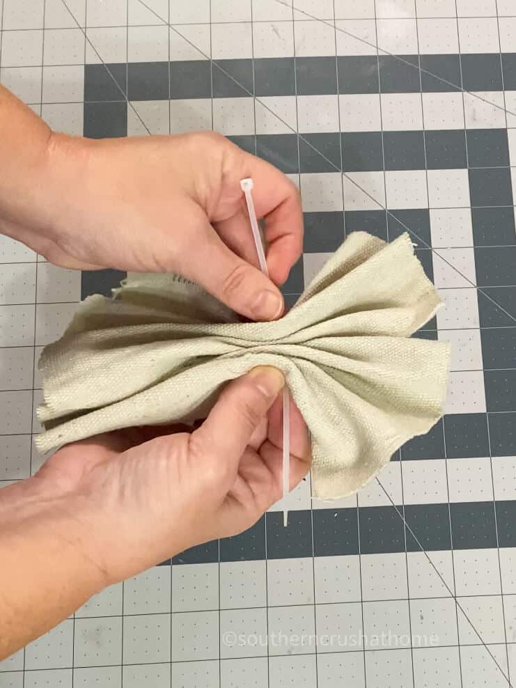 adding zip tie to drop cloth