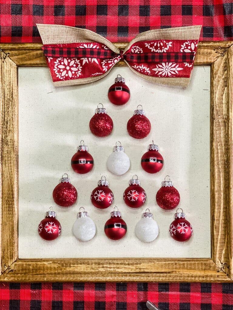 ornaments on a canvas in the shape of a christmas tree