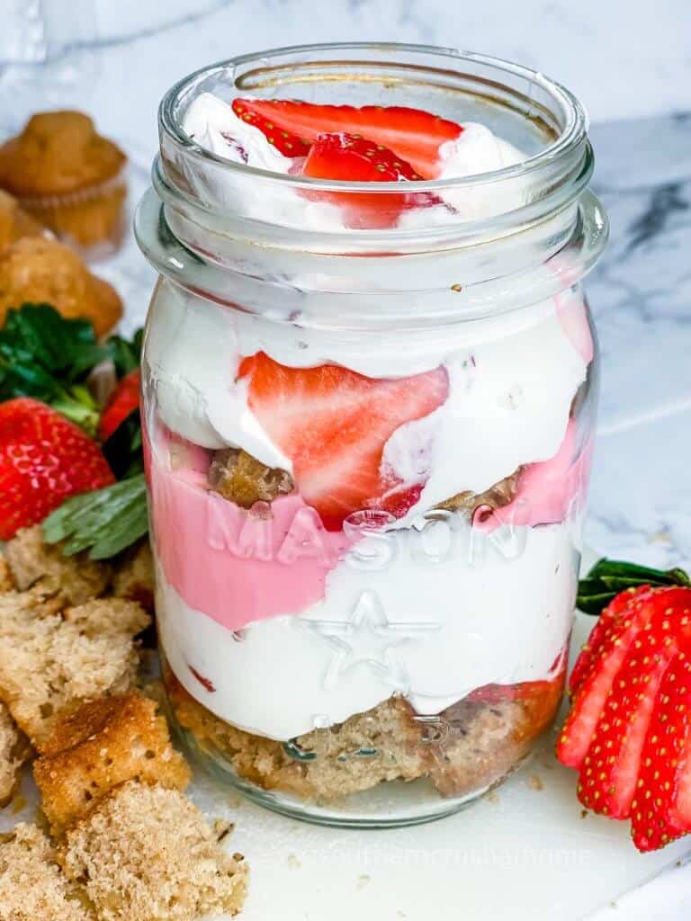 close up of strawberry shortcake trifle in a mason jar