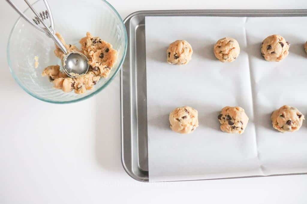 scooping cookies onto sheet pan
