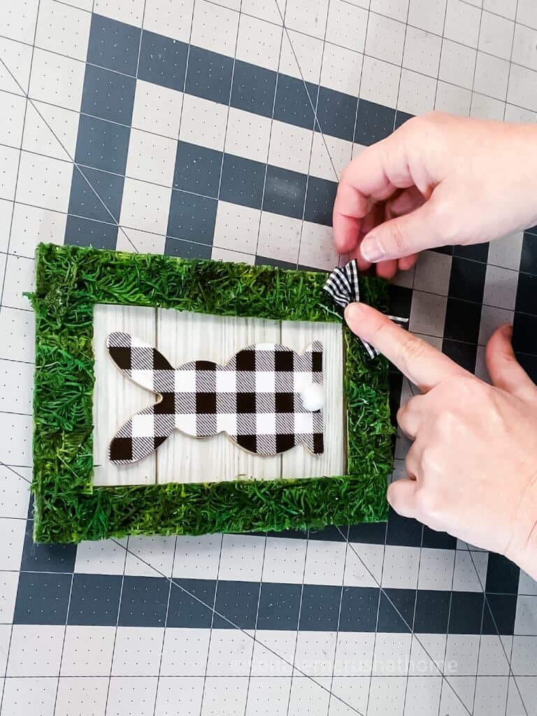 adding a bow to moss frame