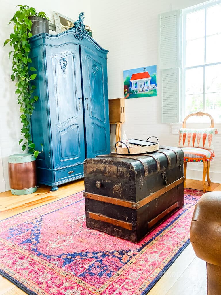 blue armoire and vintage trunk