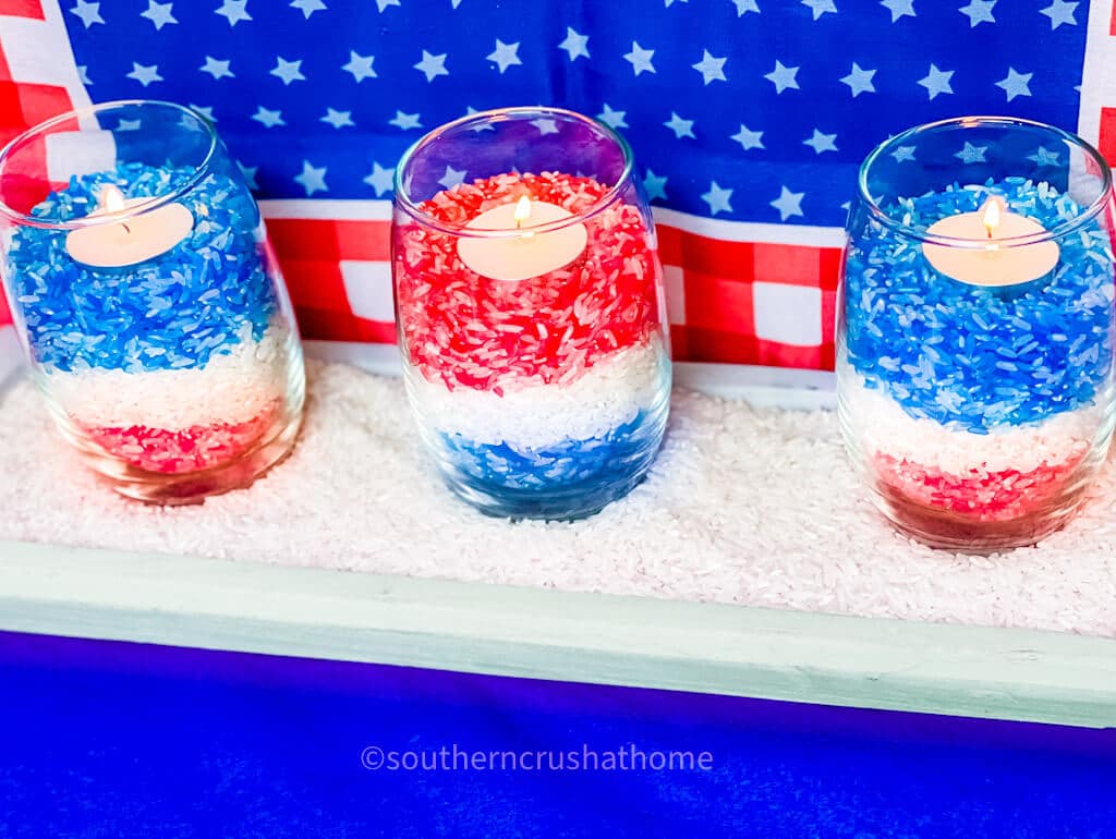 red white and blue colored rice candle trio