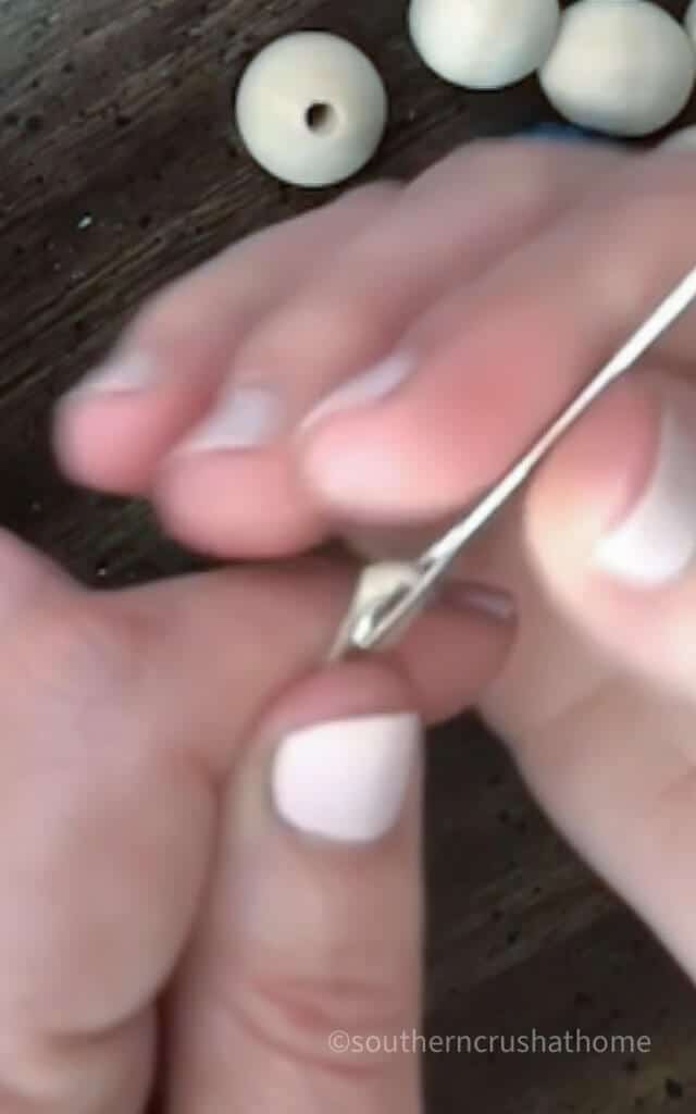 threading a large needle with hemp twine