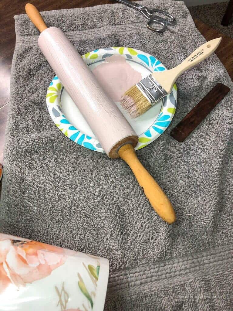 painting a DIY rolling pin light pink
