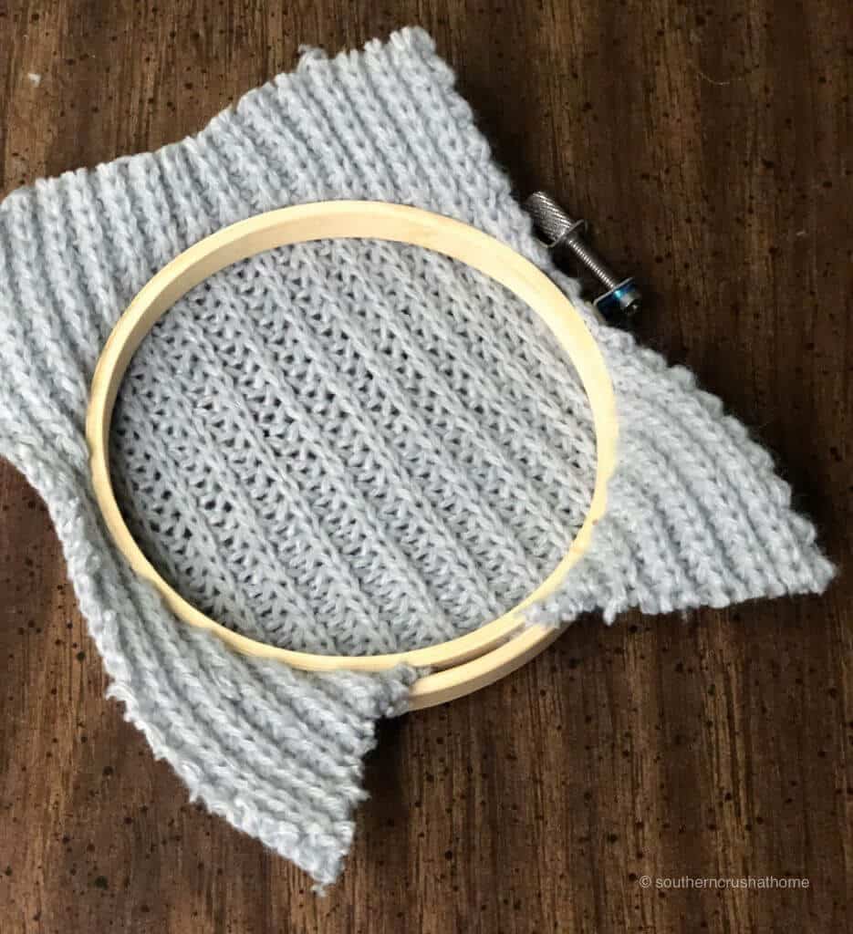 The backside of the sweater piece and the embroidery hoop