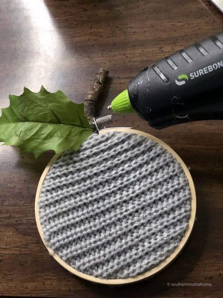 Gluing a fake stem on fabric pumpkins 