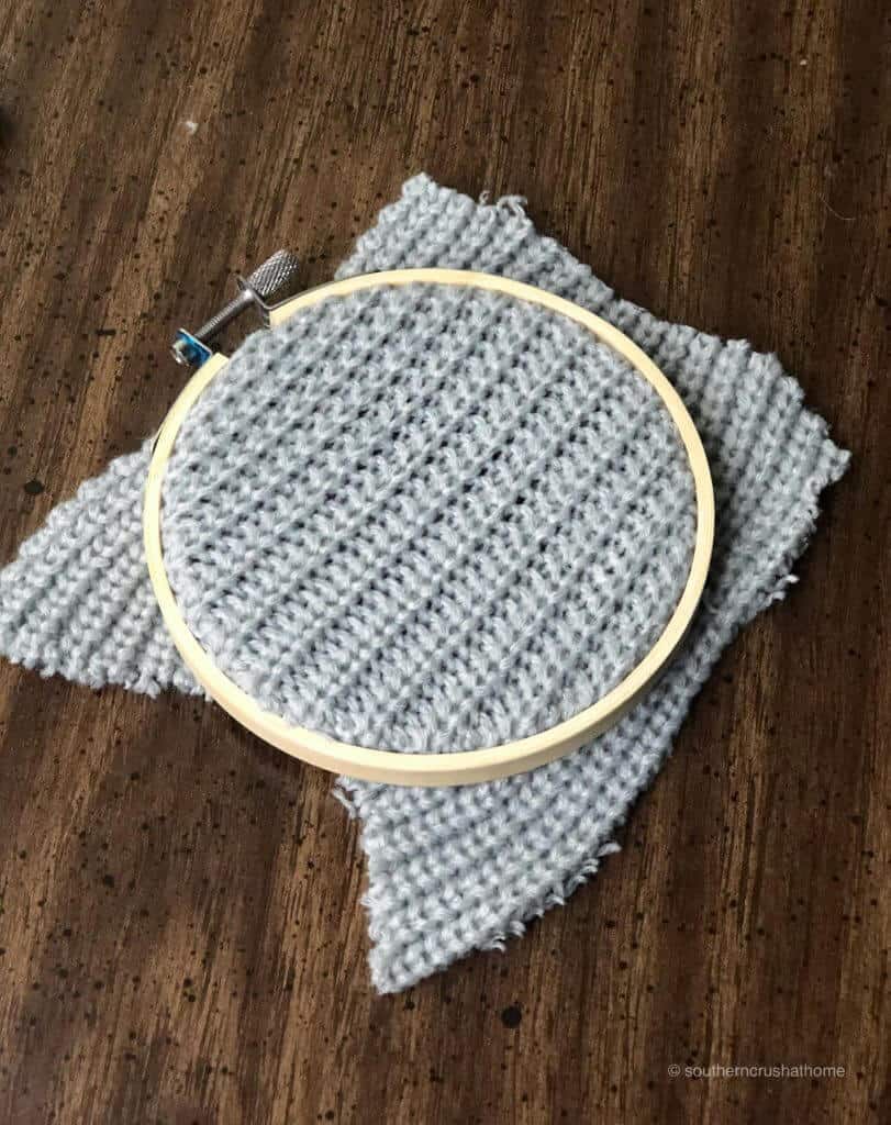 Placing the sweater inside the embroidery hoop