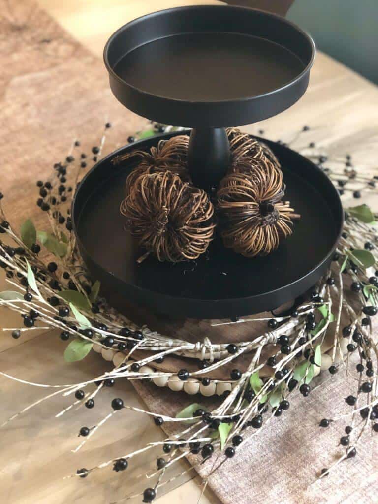 Rustic pumpkins on a black tiered tray 