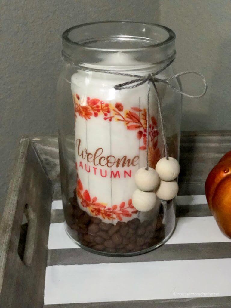 Decorated jar for fall with coffee beans and a candle