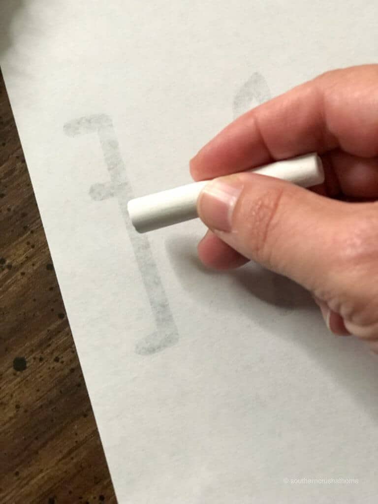 tracing the letter e with white chalk