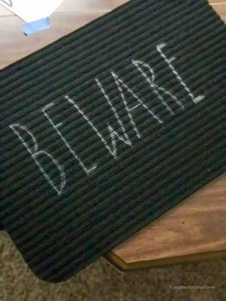 Beware in Rae Dunn Font on a black doormat