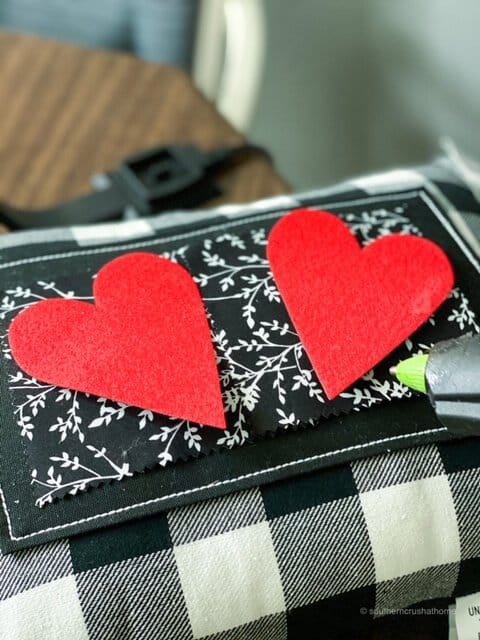 gluing felt hearts to buffalo check pillow