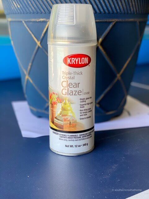 Can of Krylon clear glaze spray next to a planter painted in blue DIY chalk paint