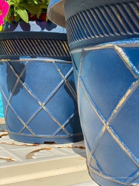 2 blue planters painted in chalk paint with gold detail on the trim