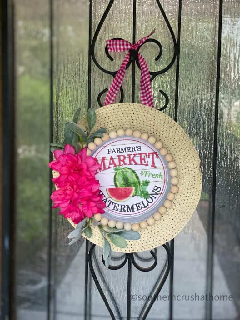 Dollar Tree summer sun hat wreath hanging on the front door