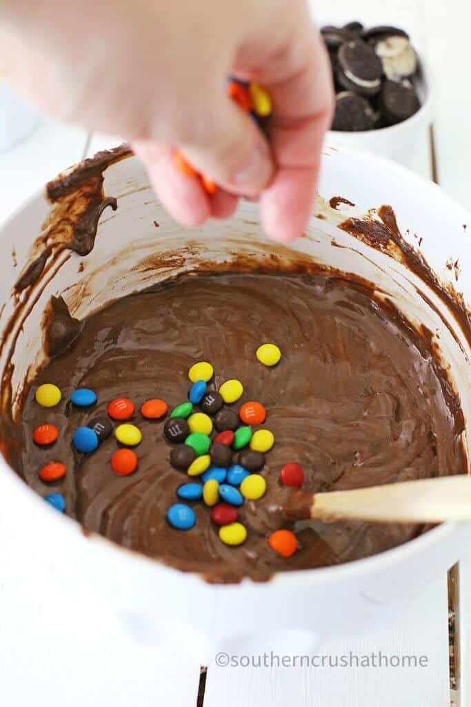 stirring in m&m candies into fudge