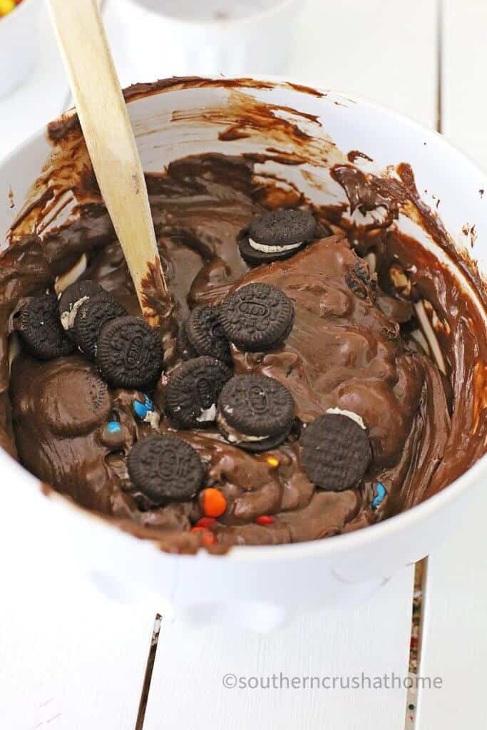 stirring in the oreo cookies into the fudge