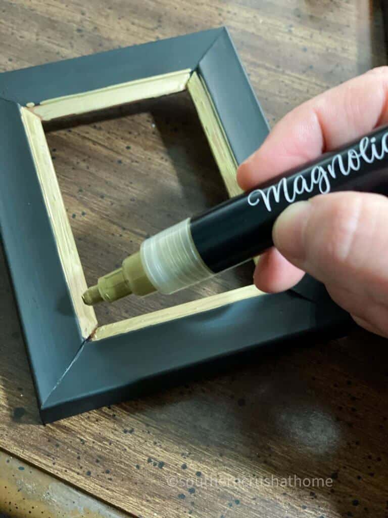 Painting edge of photo frame trim with paint pen marker