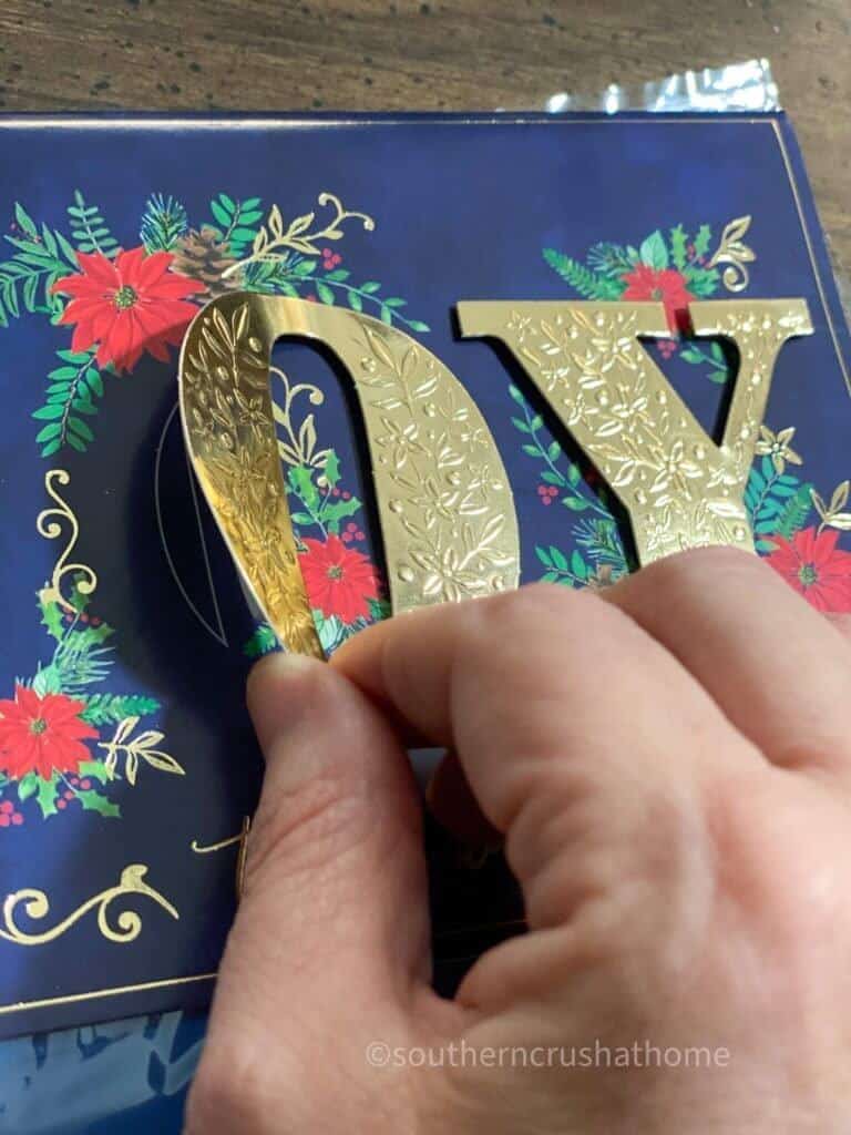 peeling off lettering from Christmas card 