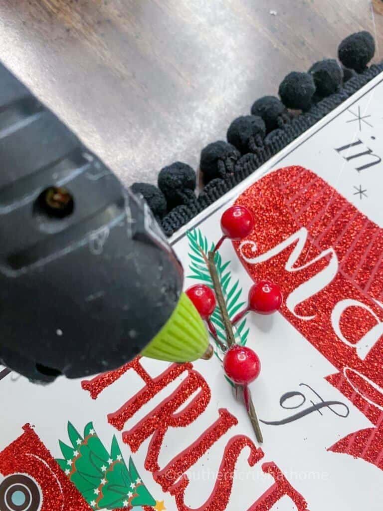 hot gluing berries onto tag