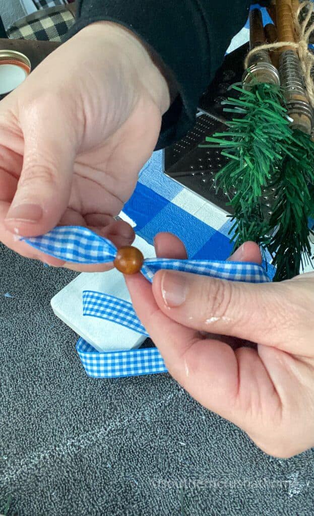 stringing wood beads to ribbon